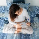 Pregnant woman taking notes in notepad